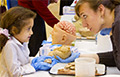 Show-and-tell with a brain at a Brain Awareness Week open house. Photo by Mike Siegel, The Seattle Times.