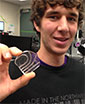 Chris Burfeind holds the prototype microfluidic device